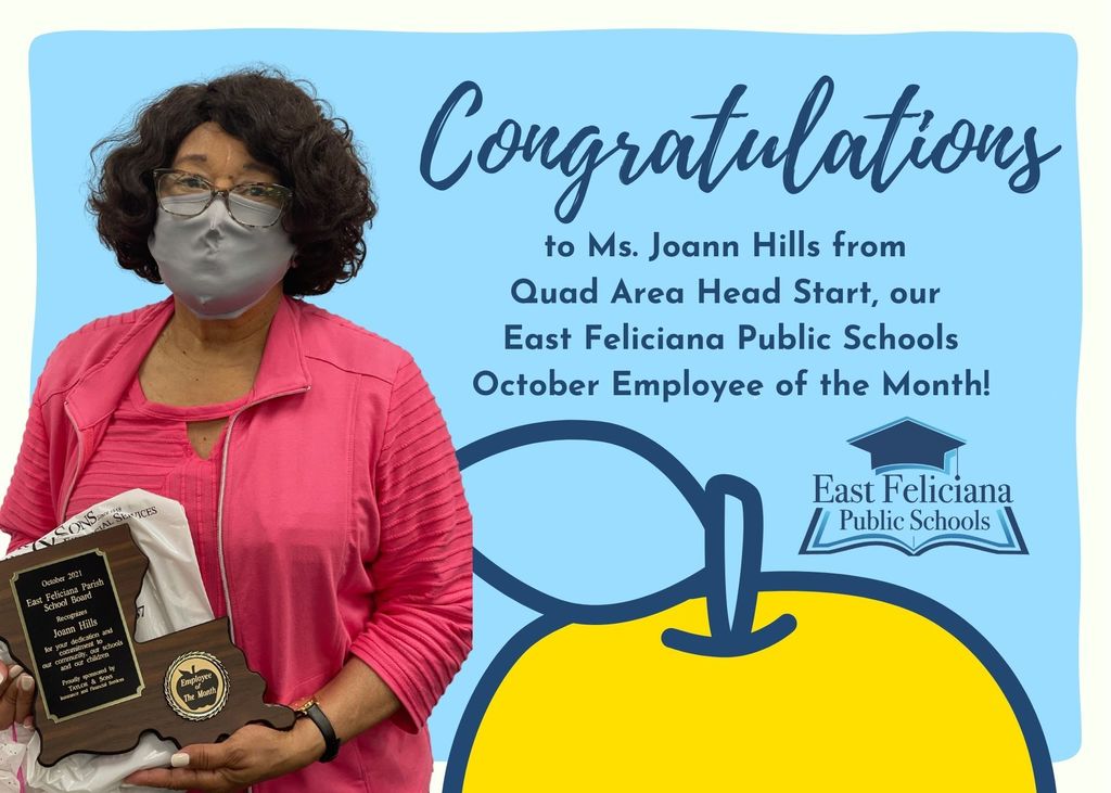 A woman wearing pink holds a Louisiana-shaped plaque. She is standing in front of a blue background with a yellow apple, the East Feliciana Public Schools graduation cap logo, and the words "Congratulations to Ms. Joann Hills from Quad Area Head Start, our East Feliciana Public Schools October Employee of the Month!