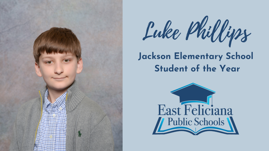A child in an unzipped gray sweater and blue checkered shirt smiles without teeth in front of a portrait backdrop. To the right of him is the East Feliciana Public Schools graduation cap logo and his name and title: Luke Phillips, Jackson Elementary School Student of the Year.