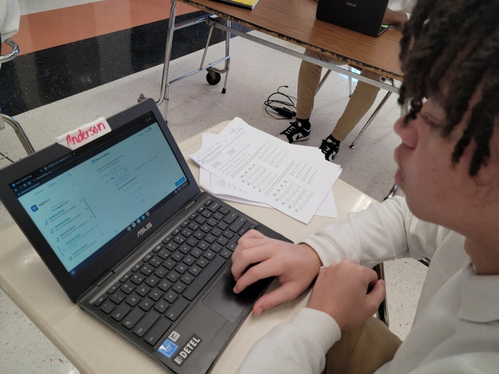 A student is working on a Chromebook.