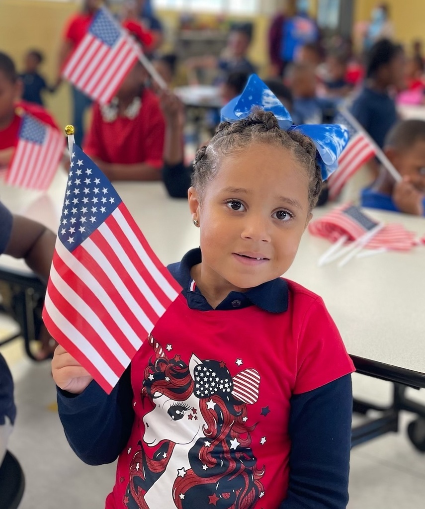 A child waves an American flag.