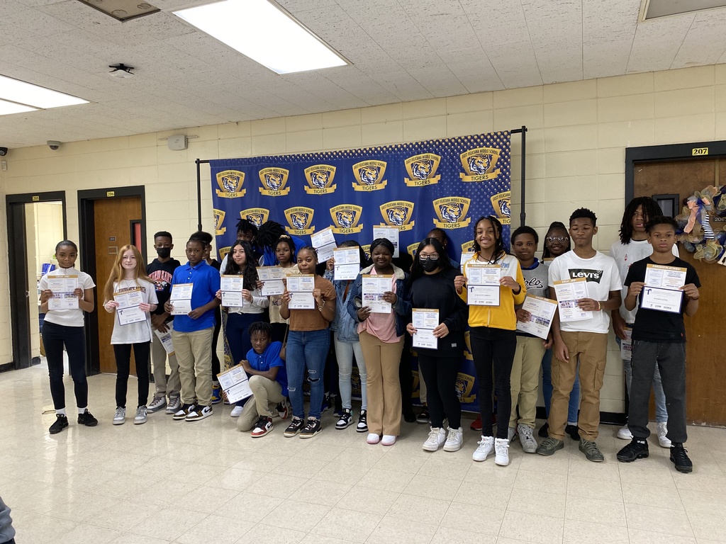 A group of students holding certificates.
